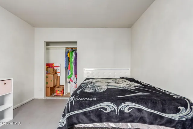 a bedroom with a bed and a dresser