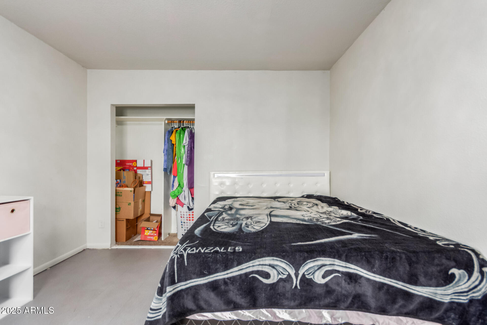 4727 West Osborn Road Phoenix, AZ 85031 - Photo 16 of 22 a bedroom with a bed and a dresser