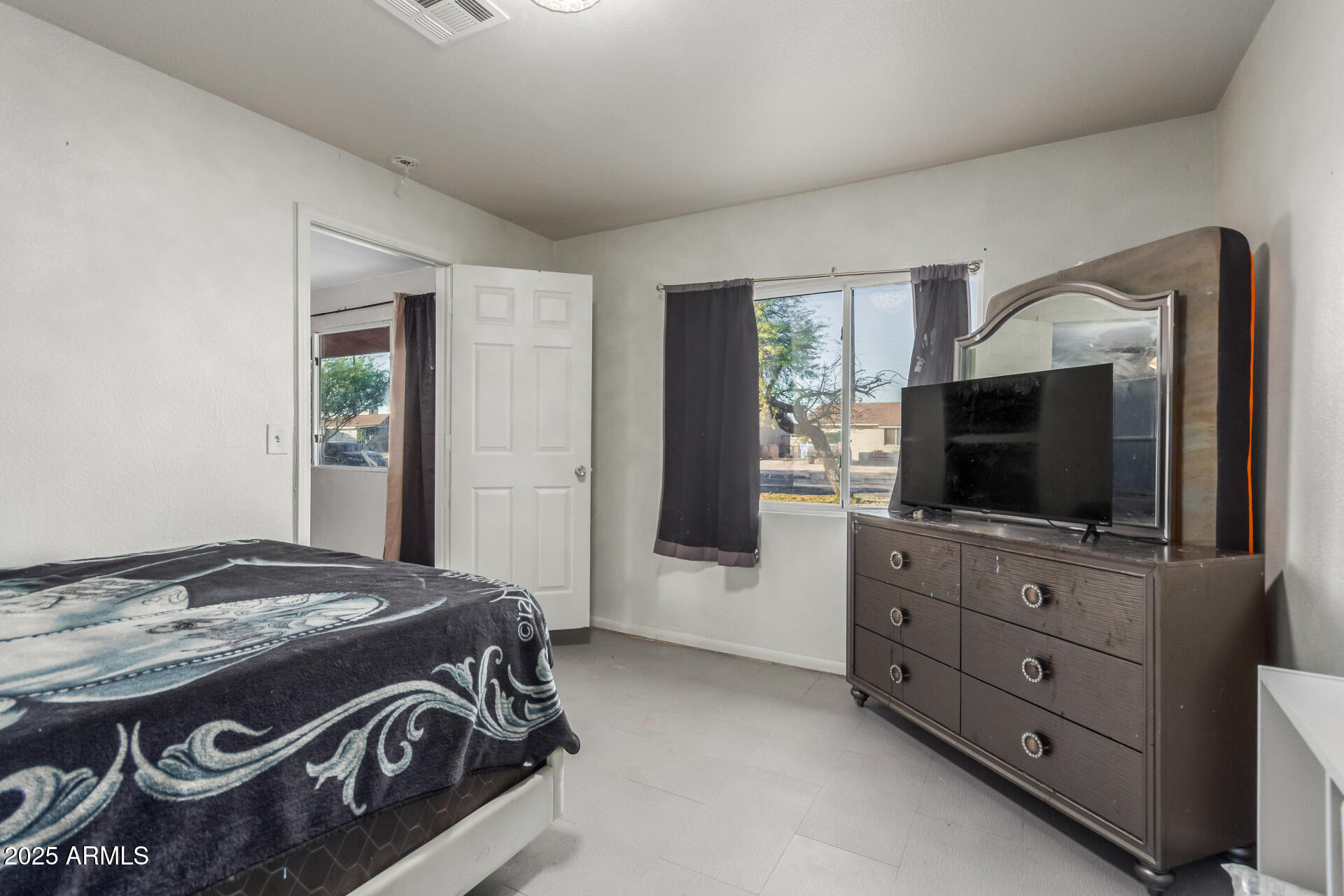 4727 West Osborn Road Phoenix, AZ 85031 - Photo 17 of 22 a living room with furniture and a flat screen tv