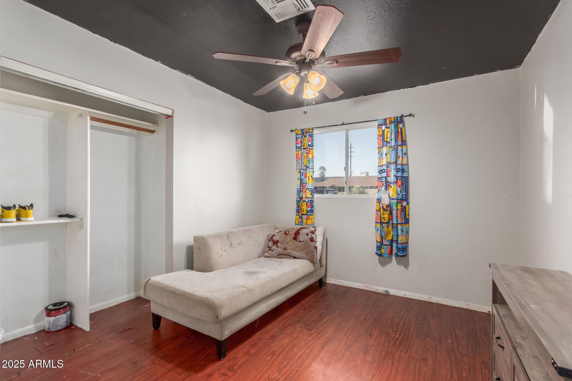 4727 West Osborn Road Phoenix, AZ 85031 - Photo 18 of 22 a bedroom with a bed and wooden floor