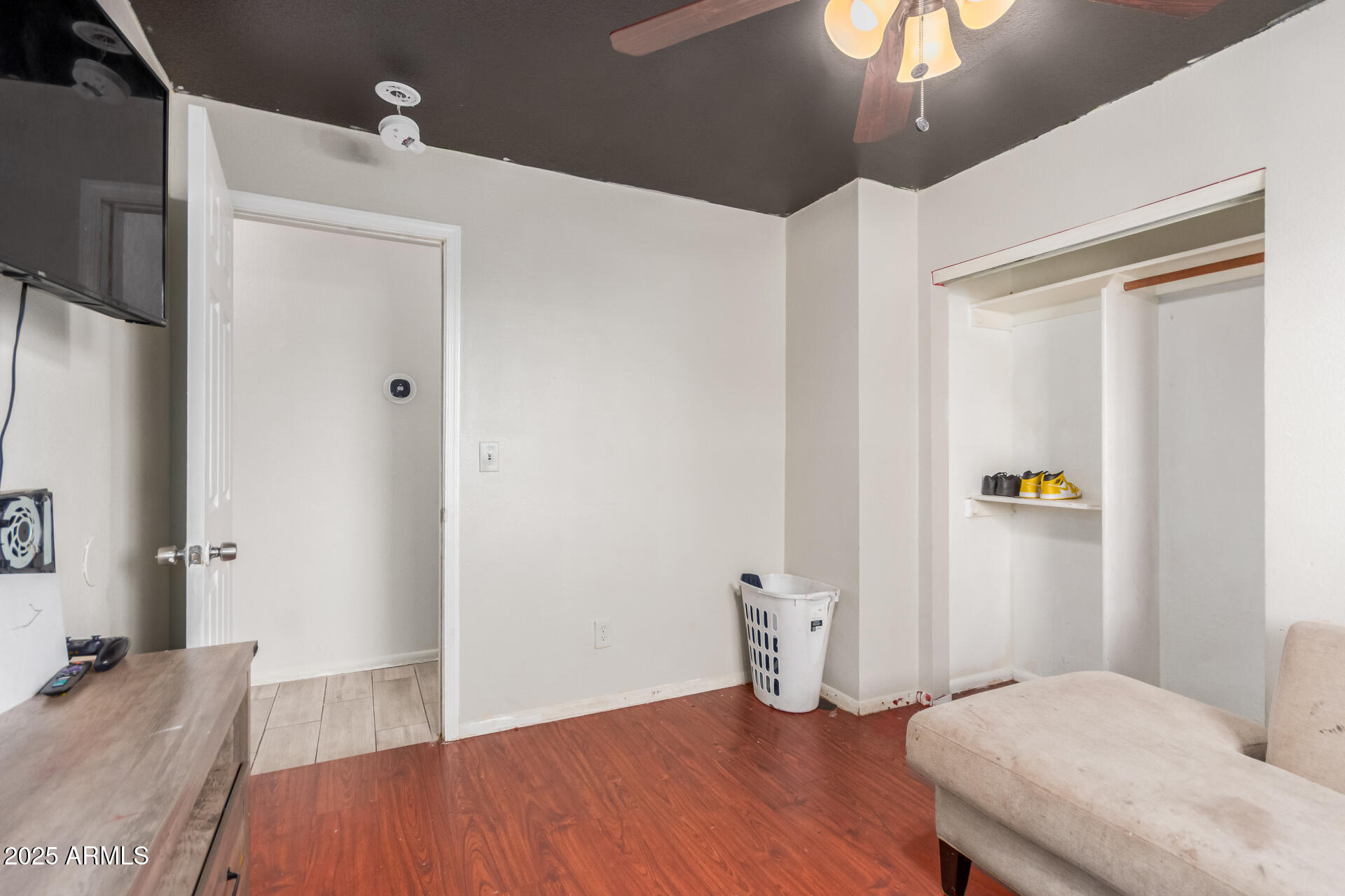 4727 West Osborn Road Phoenix, AZ 85031 - Photo 19 of 22 a bedroom with a bed and a chandelier