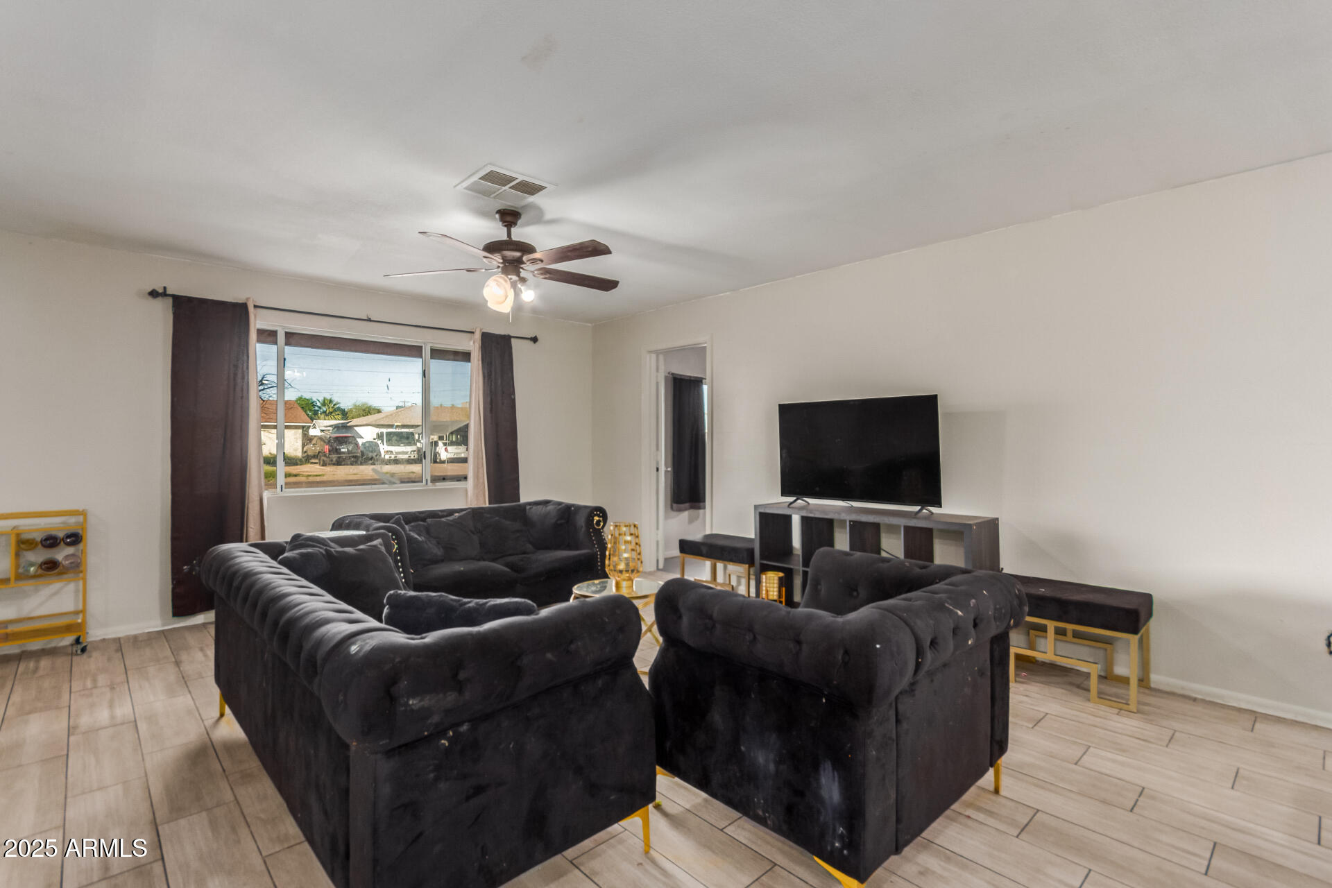 4727 West Osborn Road Phoenix, AZ 85031 - Photo 3 of 22 a living room with furniture and a flat screen tv