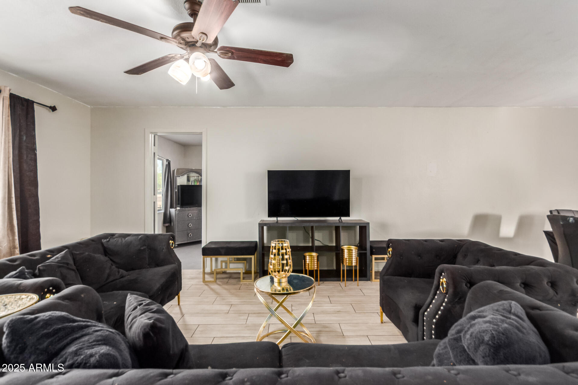 4727 West Osborn Road Phoenix, AZ 85031 - Photo 5 of 22 a living room with furniture and a flat screen tv