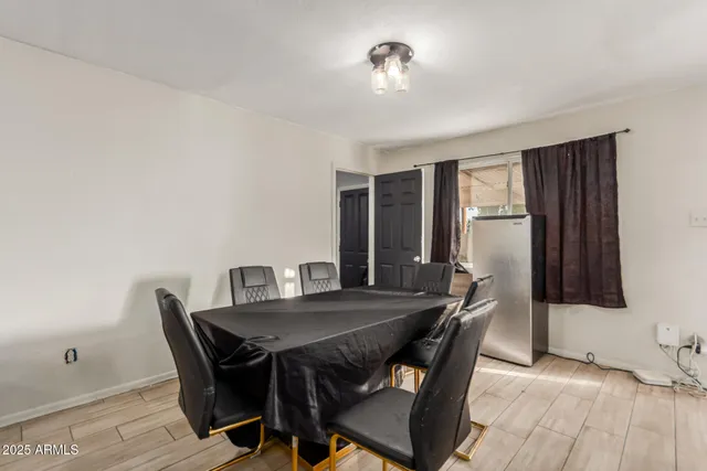 a view of a dining room with furniture and a chandelier