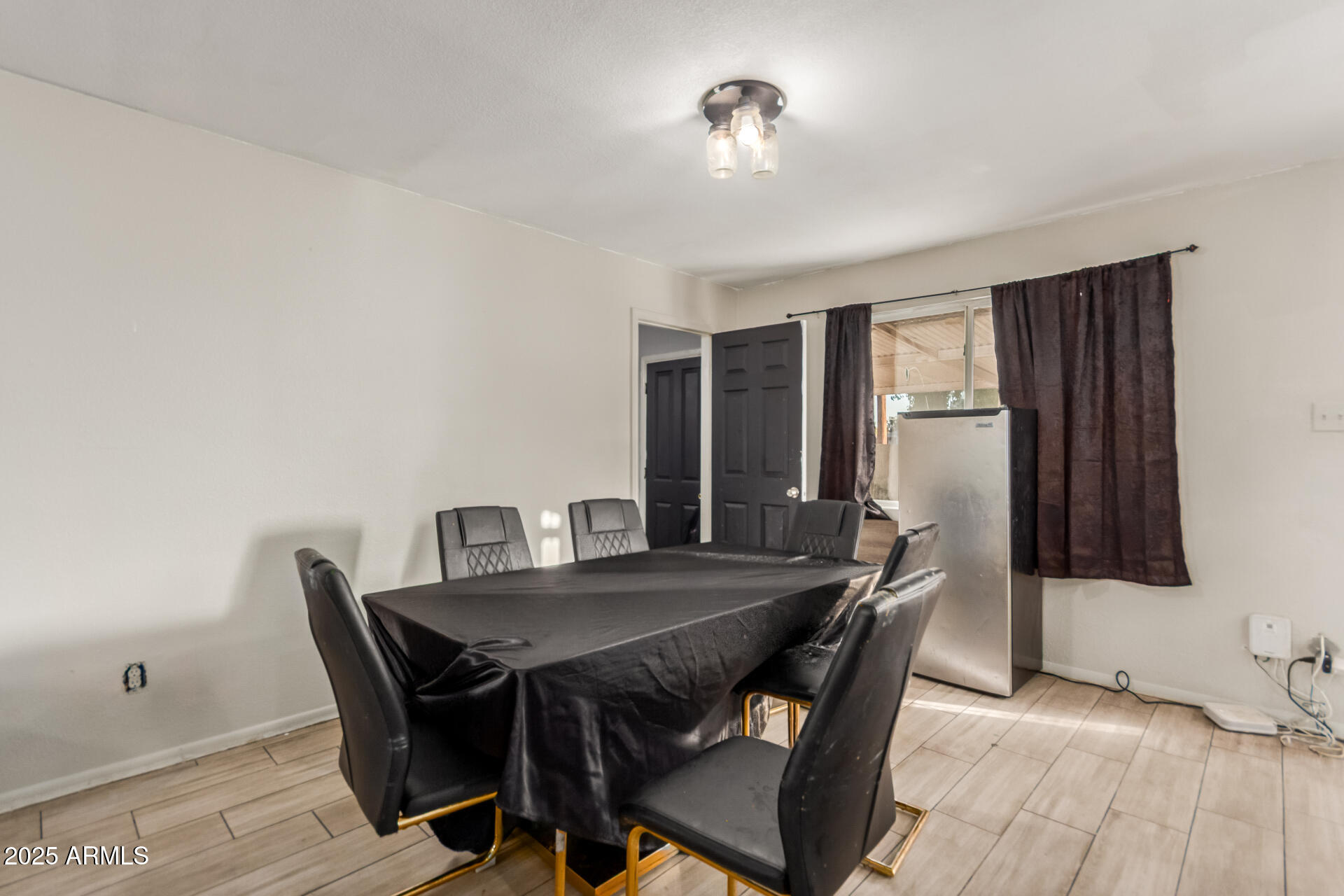 4727 West Osborn Road Phoenix, AZ 85031 - Photo 6 of 22 a view of a dining room with furniture and a chandelier