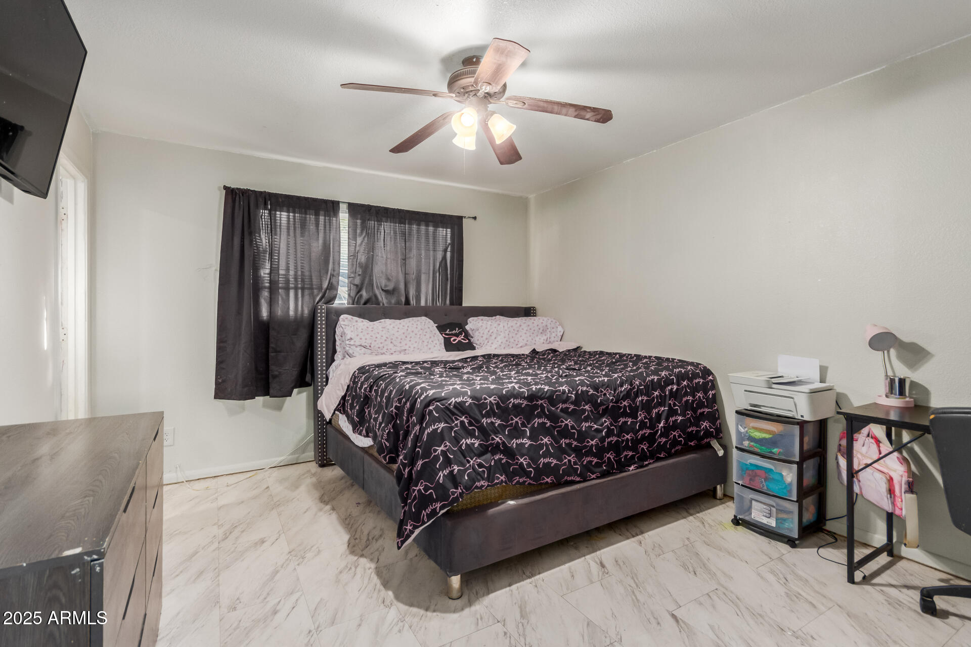 4727 West Osborn Road Phoenix, AZ 85031 - Photo 10 of 22 a bedroom with a bed and a chandelier