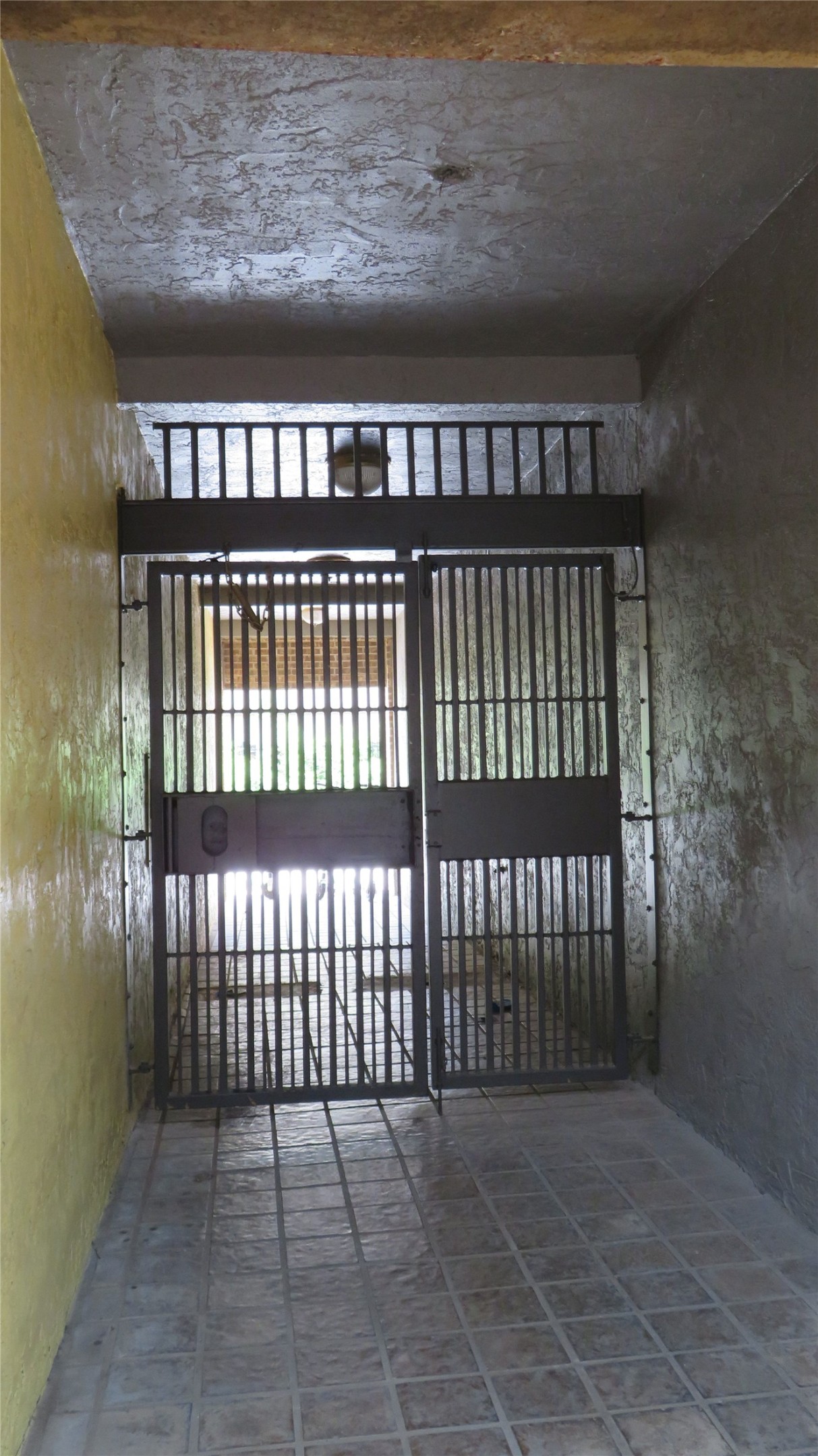 806 West 24th Street, Unit 200 Austin, TX 78705 - Photo 33 of 33 Secure entry via sturdy iron gates leading to a tiled corridor.