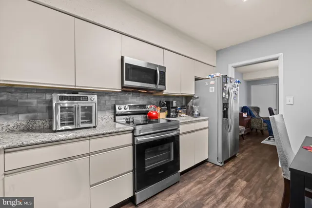 a balcony with chairs and a potted plant on a table