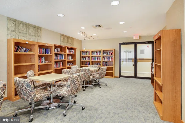 a view of a room with gym equipment and floor to ceiling window