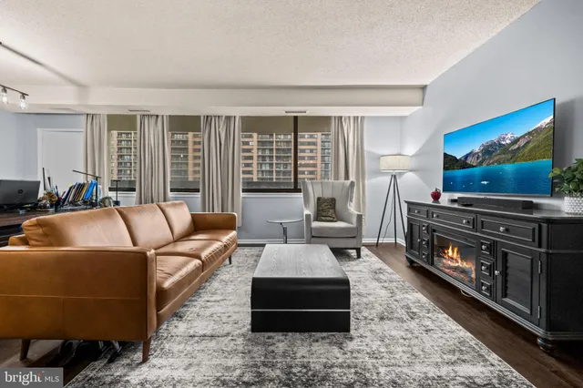 a living room with furniture or couch and a flat screen tv with wooden floor