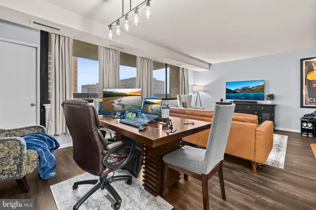 a dining room with a table chairs and kitchen view