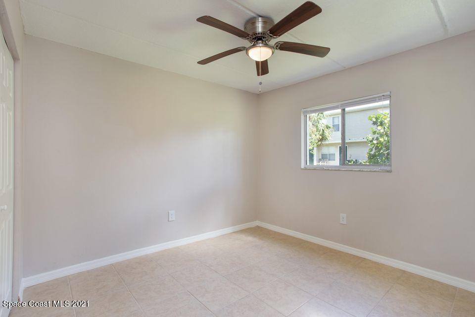 744 Ridge Club Drive, Unit 55 Melbourne, FL 32934 - Photo 11 of 15 an empty room with a window and a fan