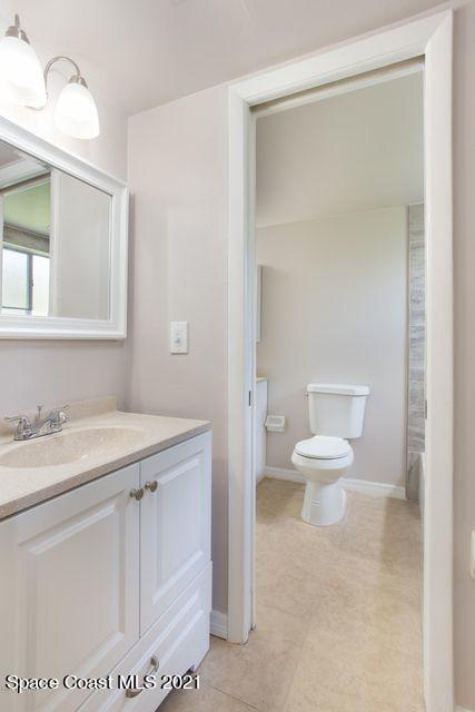 744 Ridge Club Drive, Unit 55 Melbourne, FL 32934 - Photo 9 of 15 a white toilet sitting next to a bathroom sink
