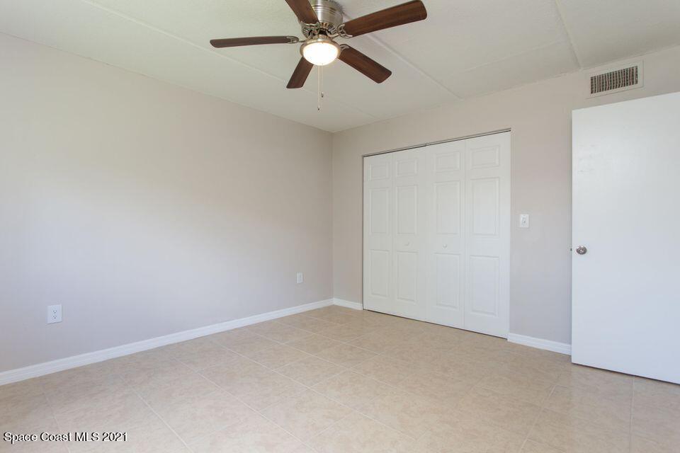 744 Ridge Club Drive, Unit 55 Melbourne, FL 32934 - Photo 10 of 15 an empty room with chandelier fan
