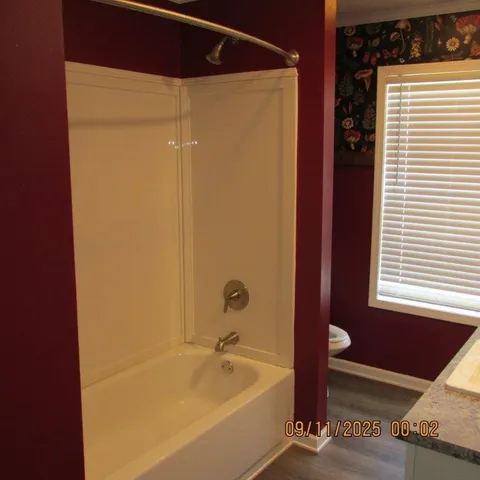 a bathroom with a tub and a shower