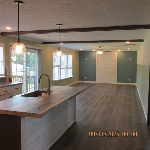 a kitchen with kitchen island a sink stainless steel appliances and cabinets