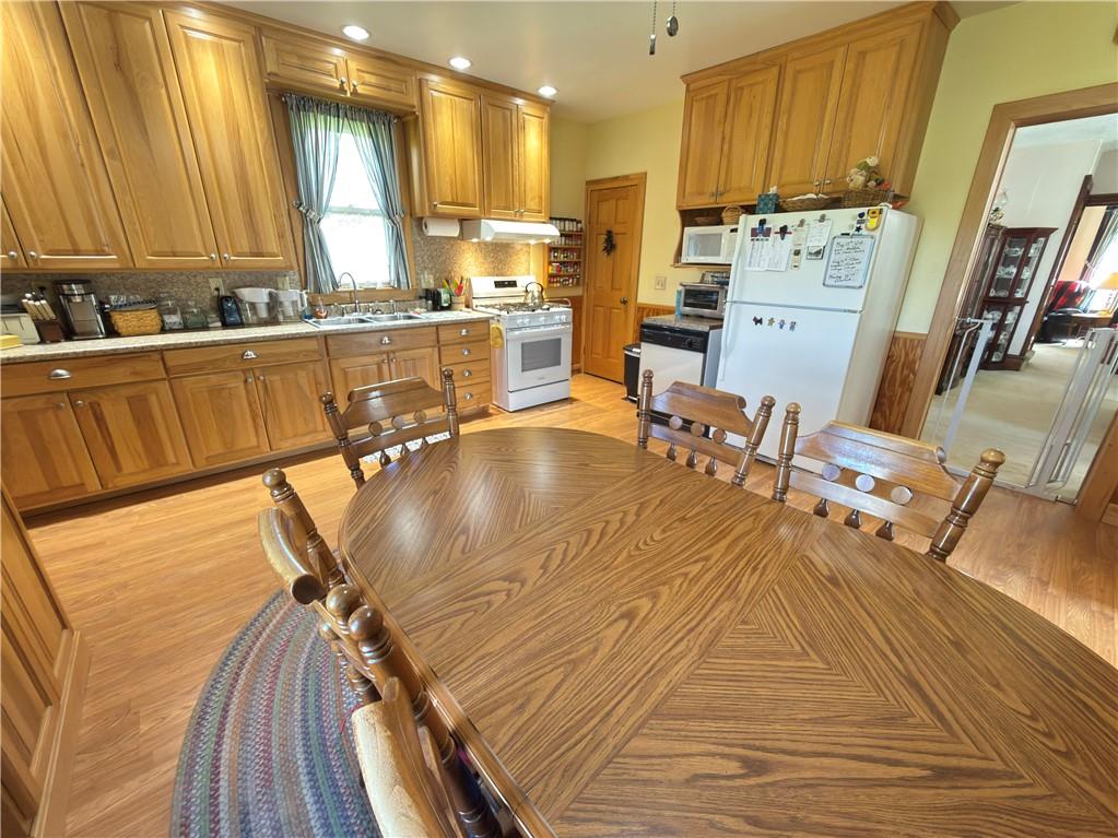 122 Coal Bank Road Greenville, PA 16125 - Photo 23 of 50 a room with stainless steel appliances kitchen island granite countertop a sink a stove and a wooden cabinets