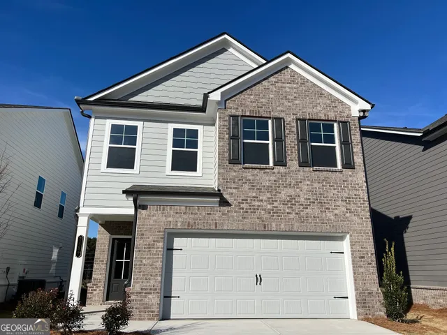 a front view of a house with garage