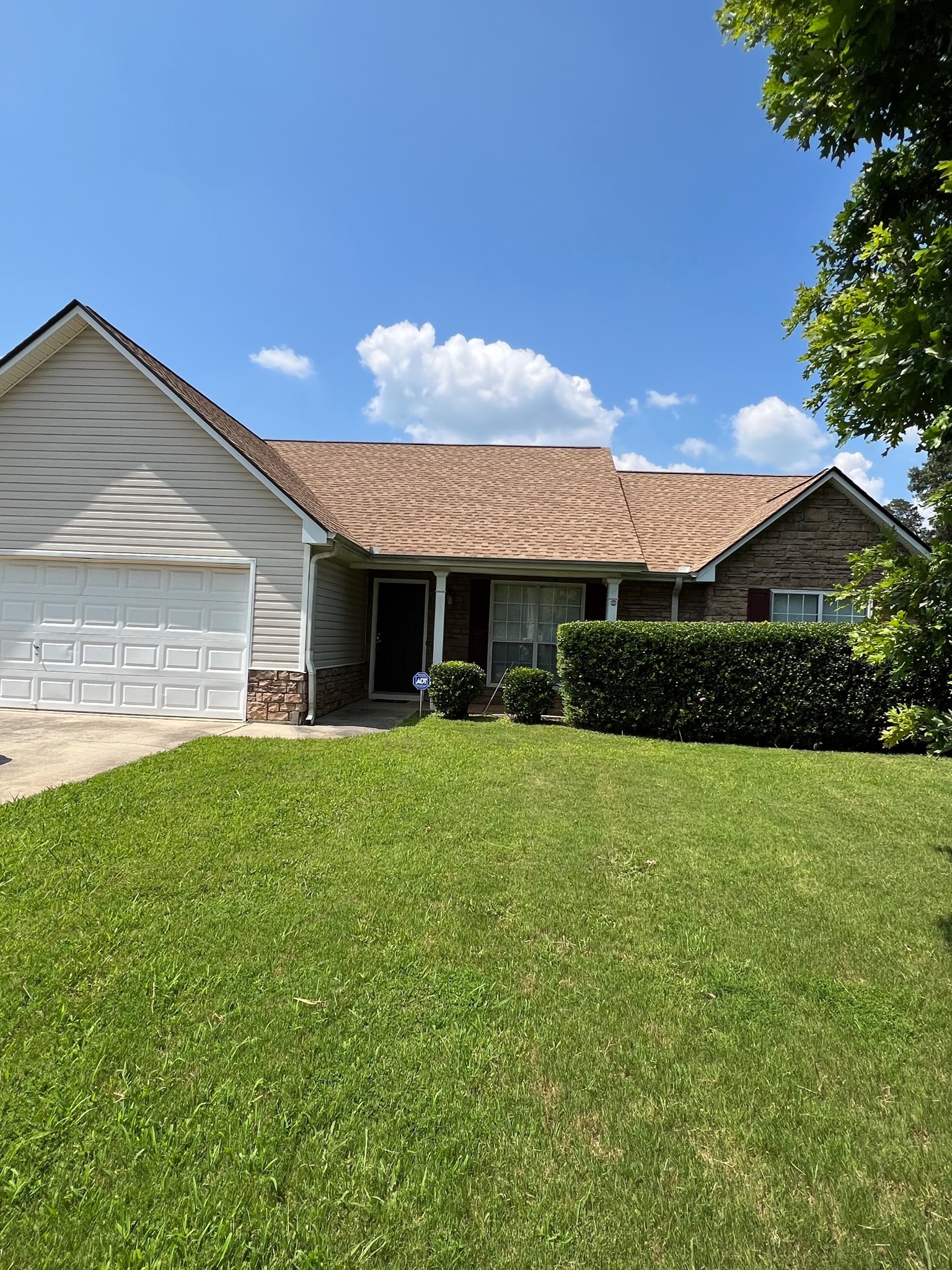 a front view of house with yard and green space