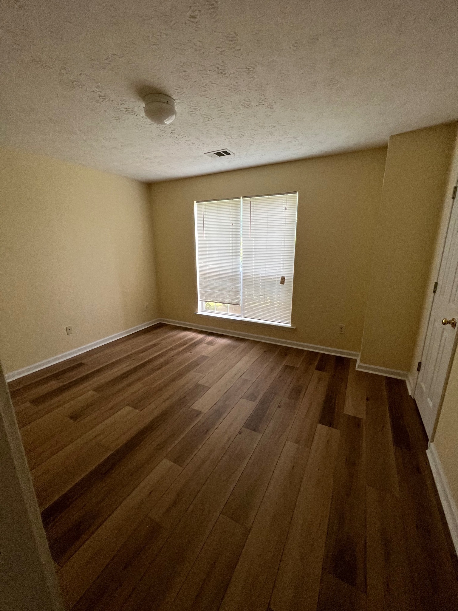 3769 Stagecoach Pass Ellenwood, GA 30294 - Photo 20 of 23 a view of an empty room with wooden floor and a window
