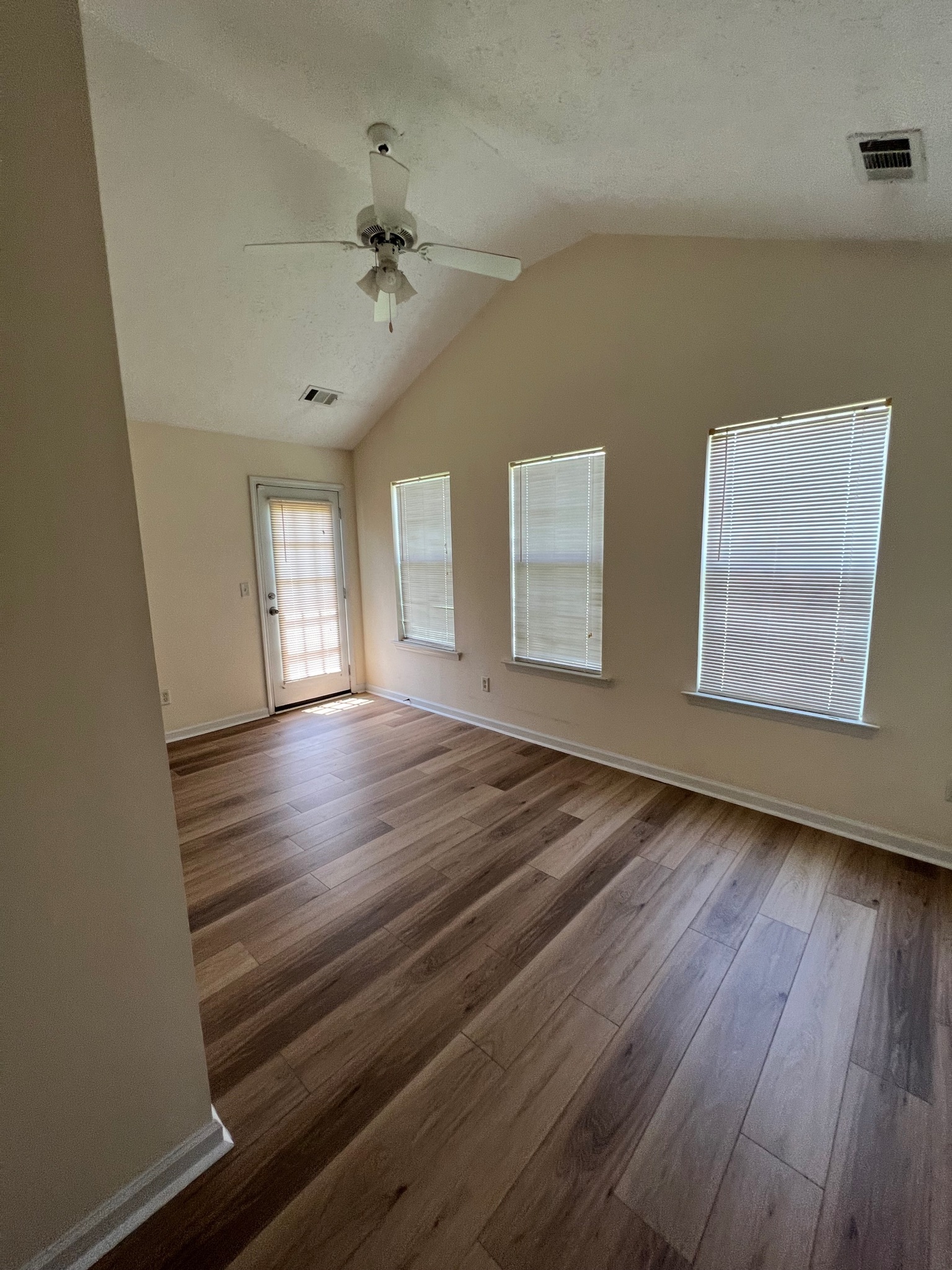 3769 Stagecoach Pass Ellenwood, GA 30294 - Photo 6 of 23 a view of an empty room with wooden floor and a window