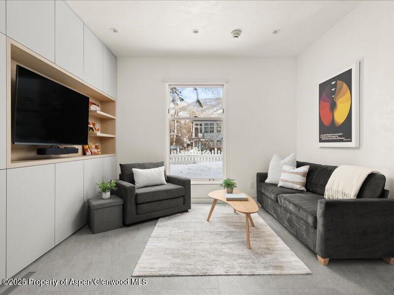 211 West Main Street, Unit 101 Aspen, CO 81611 - Photo 1 of 13 a living room with furniture and a flat screen tv