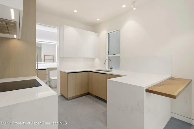 a kitchen that has a sink and a stove in it