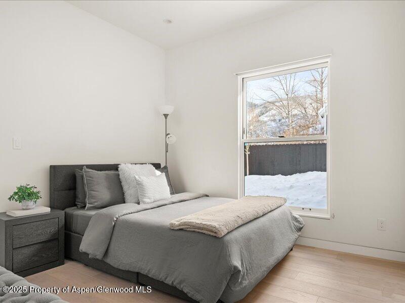 211 West Main Street, Unit 101 Aspen, CO 81611 - Photo 6 of 13 a bedroom with a bed and a window