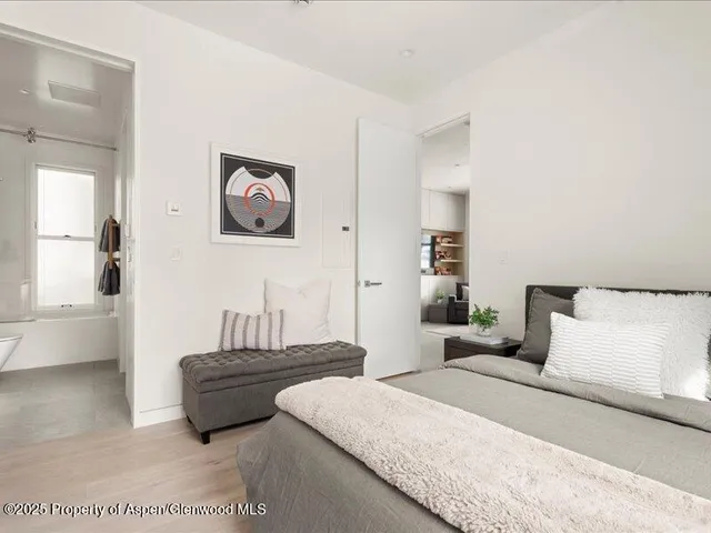 a bedroom with a bed and a couch