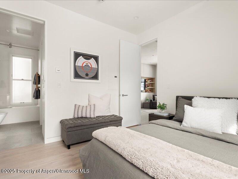 211 West Main Street, Unit 101 Aspen, CO 81611 - Photo 7 of 13 a bedroom with a bed and a couch