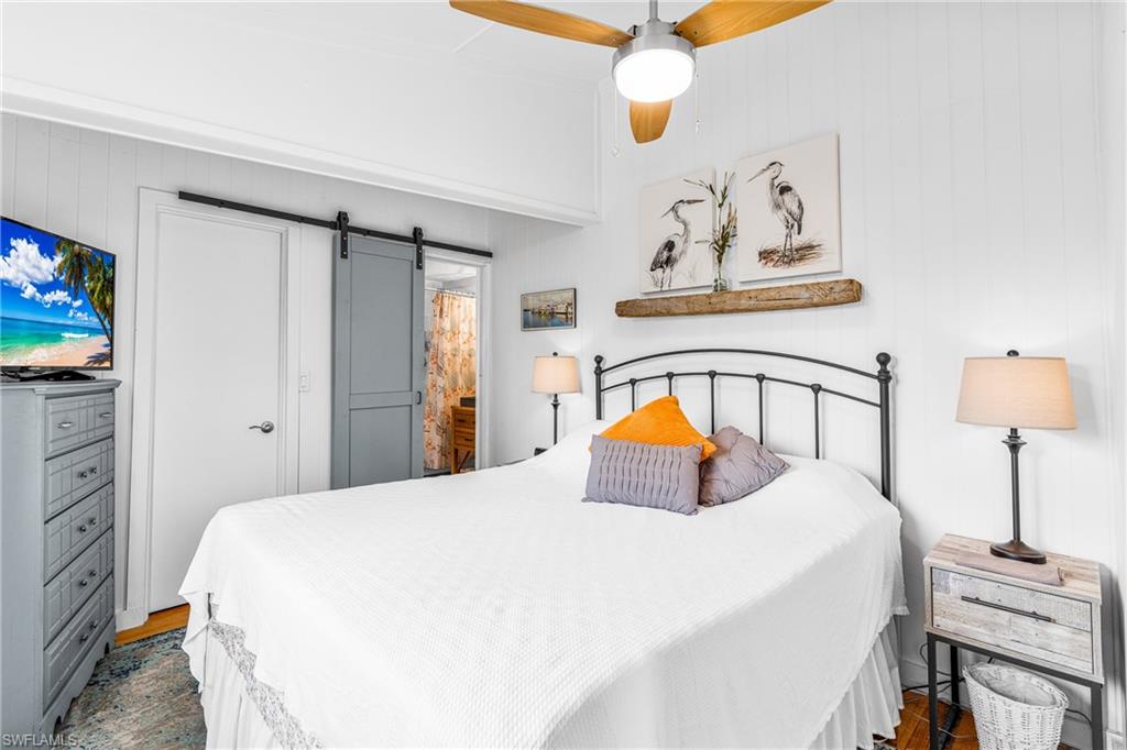 10931 Russell Road Bokeelia, FL 33922 - Photo 15 of 50 a bedroom with a bed and a closet