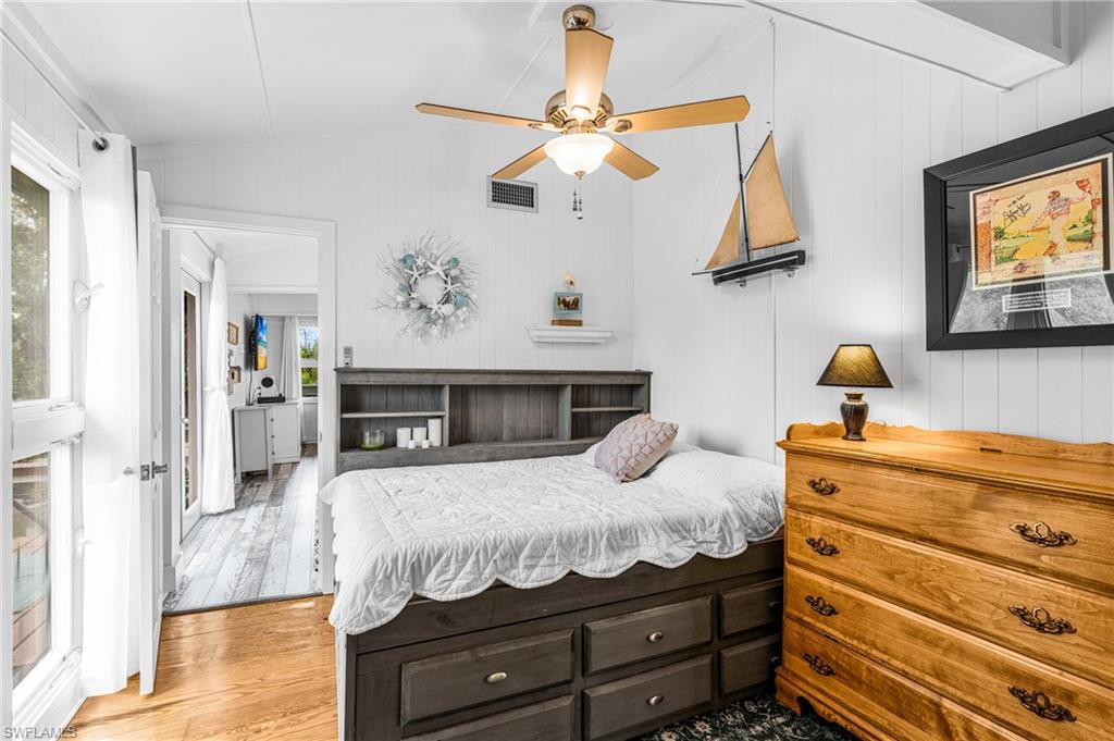 10931 Russell Road Bokeelia, FL 33922 - Photo 20 of 50 a bedroom with a bed and wooden floor