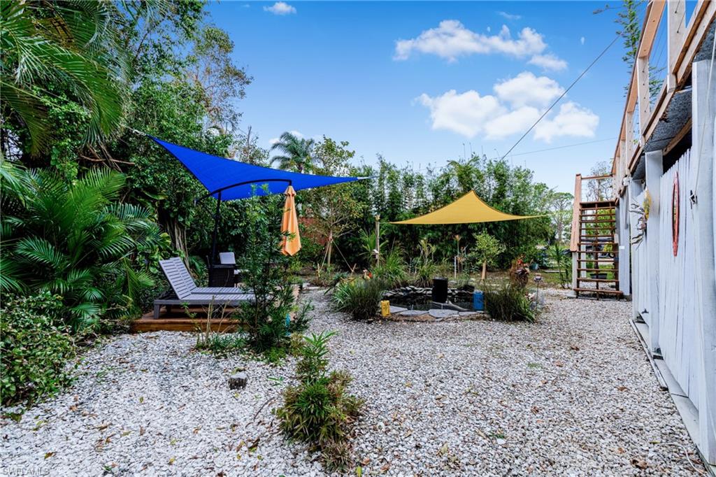 10931 Russell Road Bokeelia, FL 33922 - Photo 40 of 50 a view of backyard with outdoor seating and trees