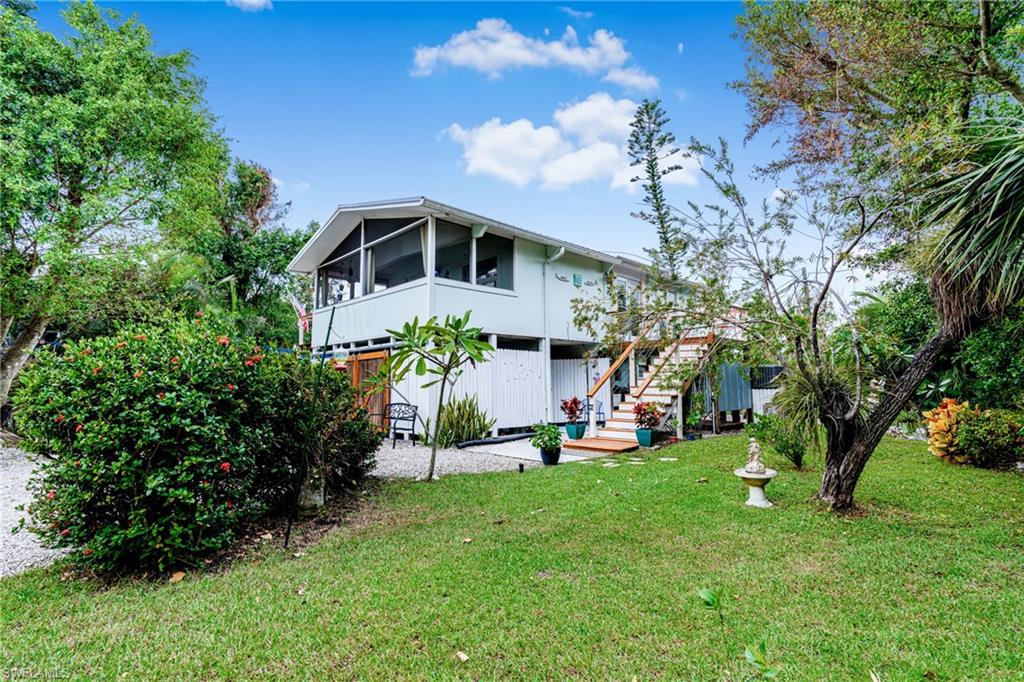 10931 Russell Road Bokeelia, FL 33922 - Photo 42 of 50 a front view of a house with a yard