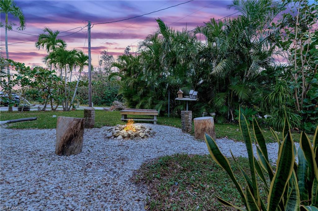 10931 Russell Road Bokeelia, FL 33922 - Photo 50 of 50 a view of a park with plants and a bench
