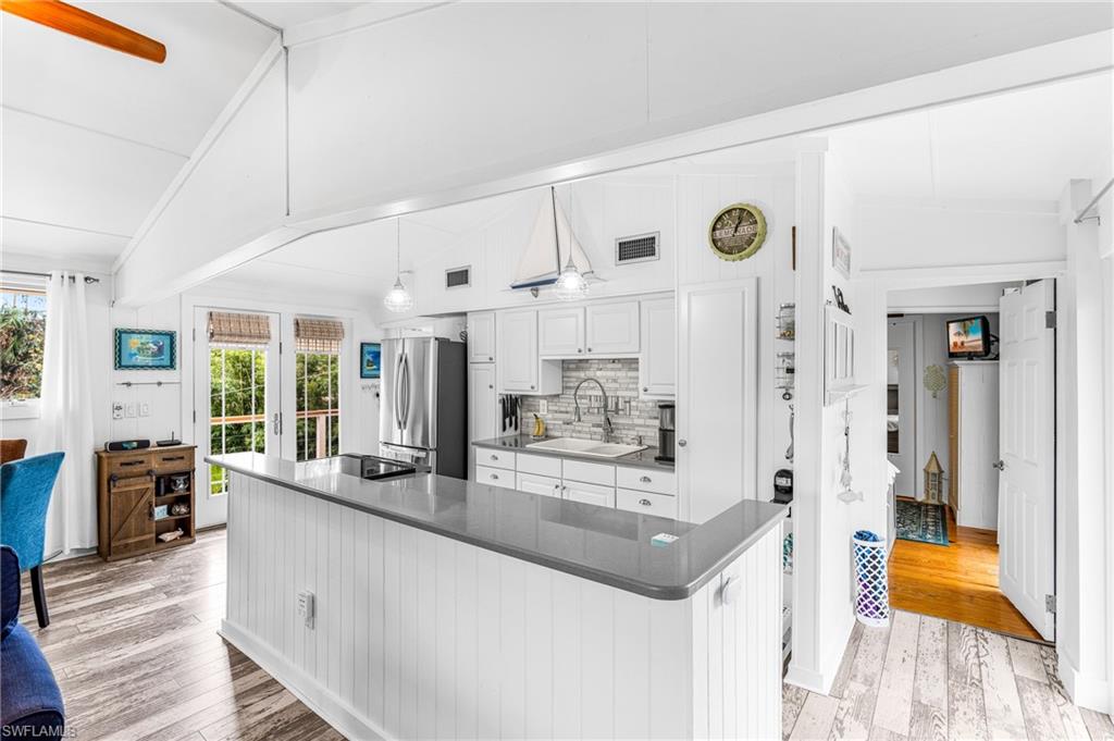 10931 Russell Road Bokeelia, FL 33922 - Photo 6 of 50 a large white kitchen with a large window