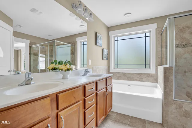 a bathroom with a granite countertop bathtub shower sink and mirror