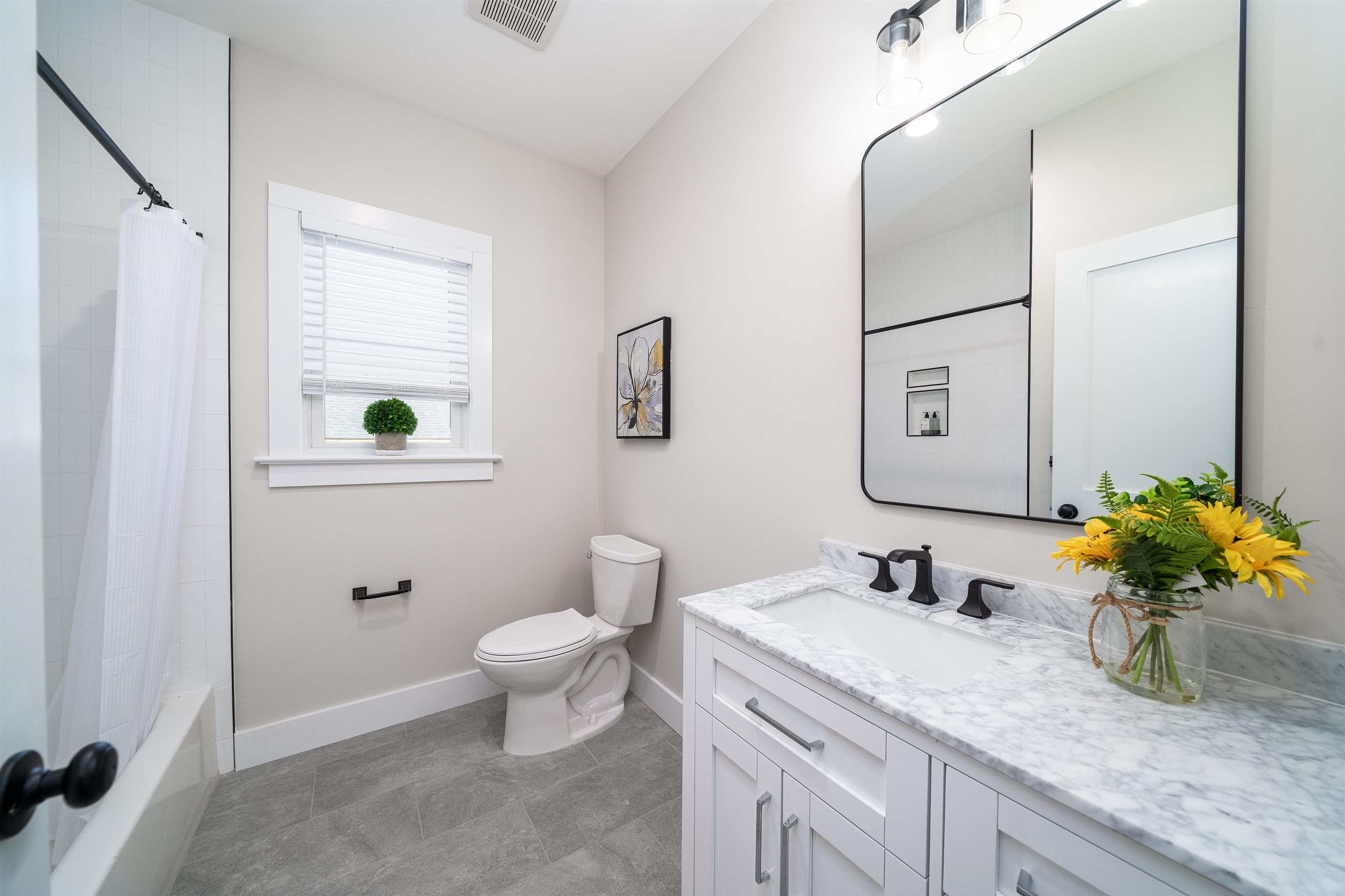 20 Orchard Street, Unit 1 Morristown, NJ 07960 - Photo 11 of 25 a bathroom with a granite countertop toilet sink and mirror