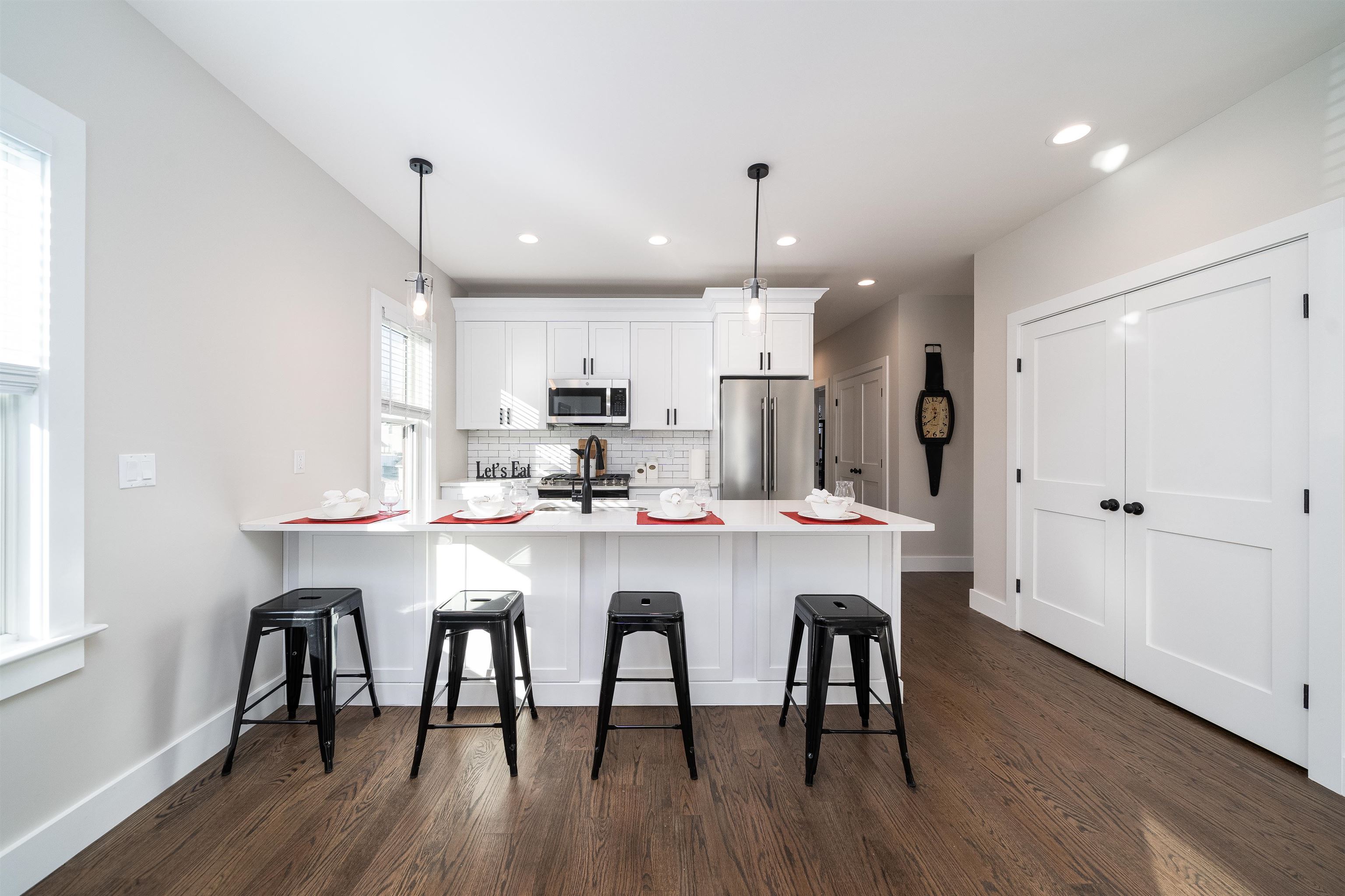 20 Orchard Street, Unit 1 Morristown, NJ 07960 - Photo 7 of 25 a kitchen with kitchen island stainless steel appliances a dining table chairs and wooden floor