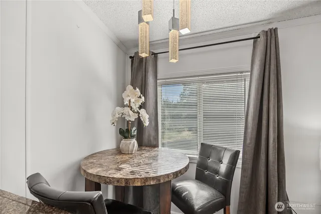 a dining room with furniture and wooden floor