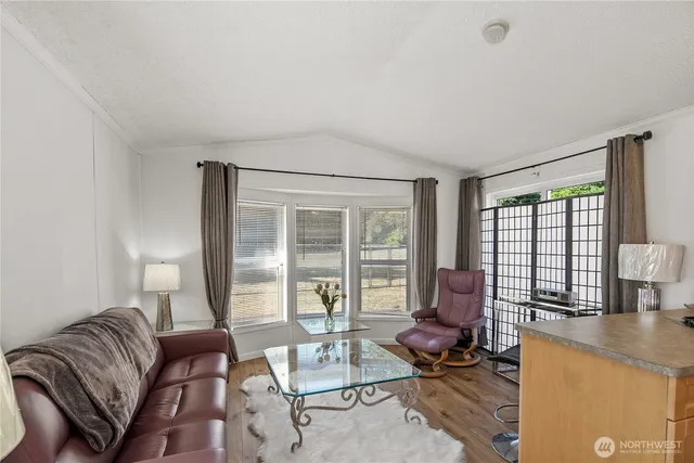 a living room with furniture and floor to ceiling windows