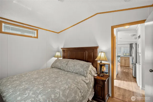 a bedroom with a bed and a mirror