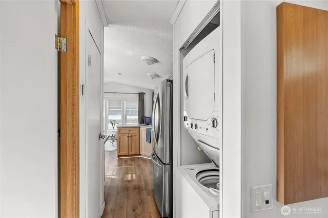 a view of a hallway with wooden floor and furniture
