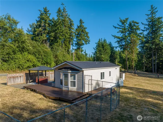 a view of a house with backyard and sitting area