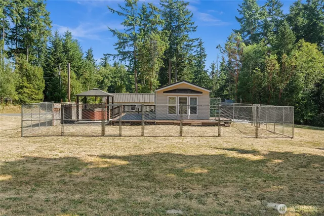 a house view with swimming pool in front of it