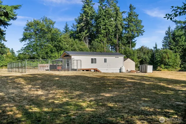a front view of house with yard and trees