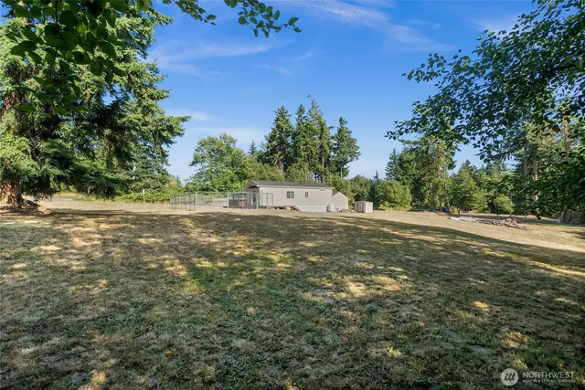 an aerial view of a house with a yard and large trees