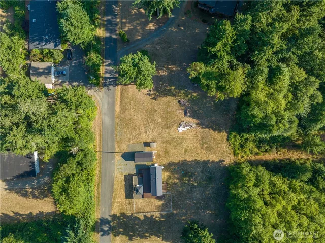 an aerial view of a house with a yard