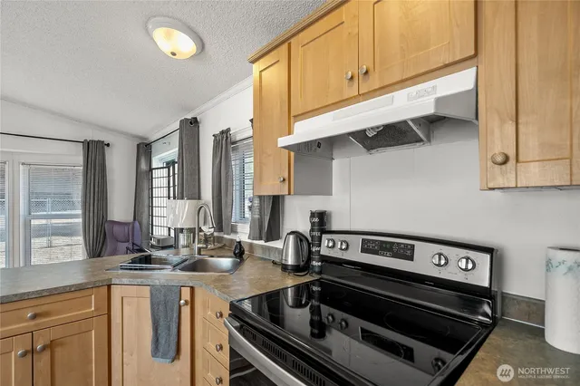 a kitchen with a stove and a sink