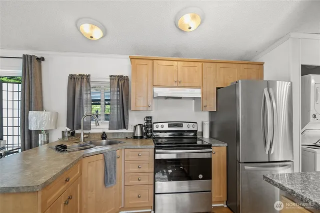 a kitchen with a stove a sink and a refrigerator